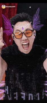 a man wearing sunglasses and a black shirt with the letters h and n on it