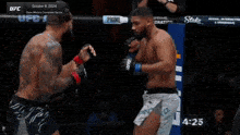 a fighter is laying on the ground during a ufc fight