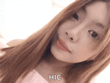 a close up of a woman 's face with hic written on the bottom right