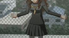 a girl in a plaid skirt stands behind a chain link fence