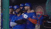 three new york mets baseball players pose for a photo in the dugout