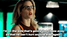 a woman wearing glasses and a red tank top is talking