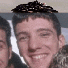 a close up of a man 's face with a cupcake on top of it