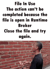 a man standing in front of a brick wall with the words file in use on the top