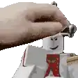 a hand is holding a hammer over a lego man .