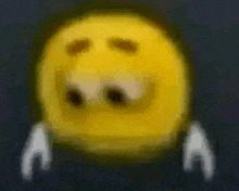 a blurry picture of a yellow smiley face with a tear coming out of it 's eyes .