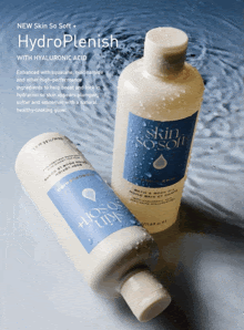 two bottles of skin so soft bath and body oil are sitting in water