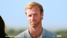 a man with a beard on a nbc destination x poster