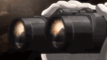 a person is holding a pair of binoculars with the letters nfr on the lenses