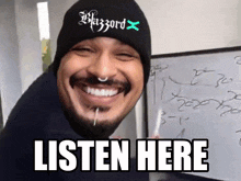a man wearing a beanie that says blizzard x on it
