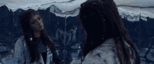 a woman looks at herself in a mirror
