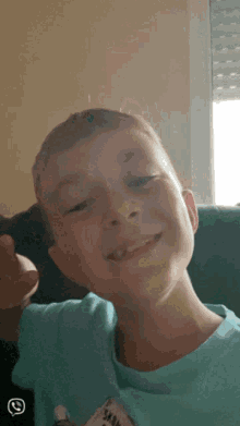 a young boy wearing a blue shirt that says ' snoopy ' on it