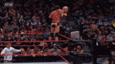 a wrestler in a ring with the aew logo on the ring