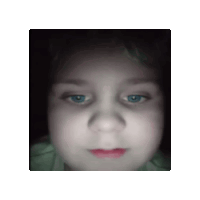 a close up of a girl 's face with blue eyes and red lips .