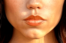 a close up of a woman 's face with a few freckles