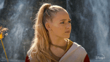 a woman with a braided ponytail and a disney logo on the bottom