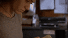 a close up of a person holding a piece of paper .