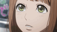 a close up of a girl 's face with a slight smile