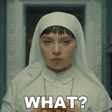 a woman in a nun 's outfit is asking the question " what "
