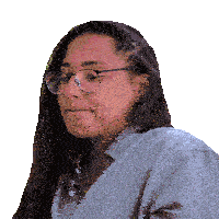 a woman wearing glasses and a grey shirt looks to the side