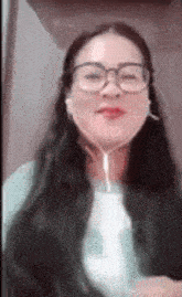 a woman wearing glasses and headphones is making a face .