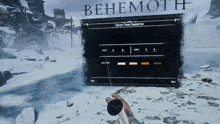 a person holding a controller in front of a screen that says behemoth