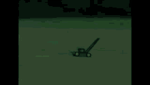 a green lawn mower is flying through the air in a field .