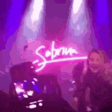 a group of people are dancing in front of a sign that says sabrina .