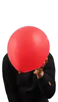 a person blowing up a red balloon in front of their head