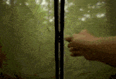 a person is opening a zipper on a green cloth