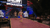 a wrestler walks down the aisle of a wrestling dynamite show