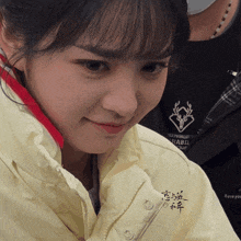 a woman wearing a yellow jacket with rabid written on the front