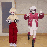 a girl in a red jacket is standing next to a girl in a white hat