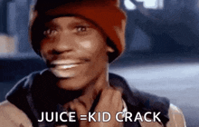 a man wearing a red hat is smiling and says `` juice = kid crack '' .