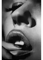 a black and white photo of a woman 's mouth with her tongue out