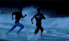 a couple of men running on a beach at night