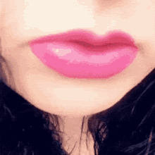 a close up of a woman 's mouth with pink lipstick