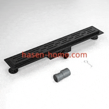 a black shower drain is sitting on top of a white table next to a handle .