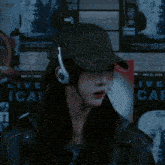 a woman wearing headphones and a hat that says tech