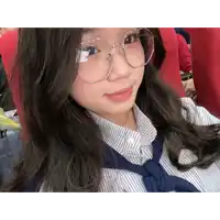 a girl wearing glasses and a striped shirt takes a selfie