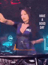 a woman in a police uniform is dancing in front of a sign that reads have a good day