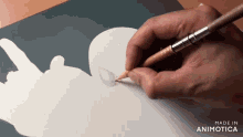 a person is drawing a silhouette with a pencil and the words made in animatica are visible in the corner