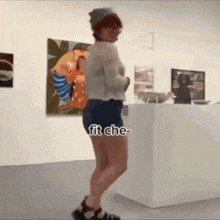 a woman in shorts is standing in front of a painting with the caption fit che-