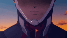 a close up of a man 's face with a helmet on his head