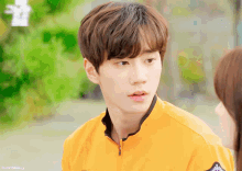 a close up of a person wearing a yellow jacket with a sticker on the sleeve that says ' seoul police '