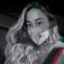 a woman wearing a face mask with a seahorse design