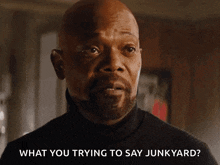 a man in a black turtleneck is asking what you trying to say junkyard
