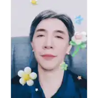 a man with his eyes closed is surrounded by balloon flowers and stars .