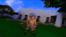 a blurry picture of a boy standing in front of a white house