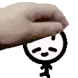 a hand is holding a cartoon character with a face on it .